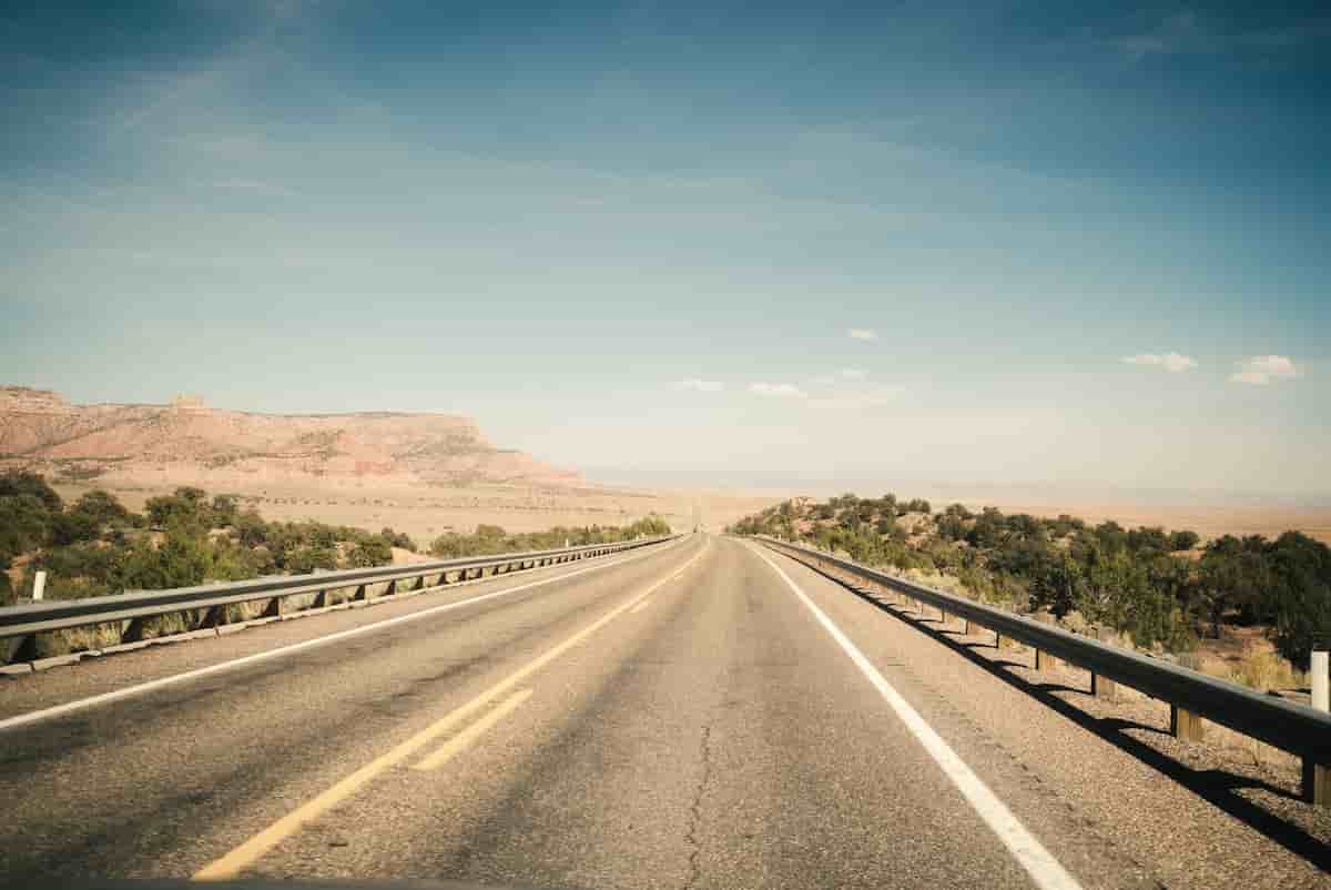 Two-lane highway crossing high desert grassland toward mountains near Sierra Vista, Arizona